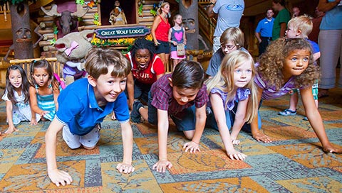 Kids crawl along the ground in a game they're playing